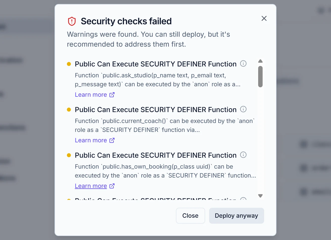 Draftbit dialog titled Security checks failed: warnings that database functions such as ask_studio, current_coach and has_own_booking can be run by the anon role, with a Close and a Deploy anyway button