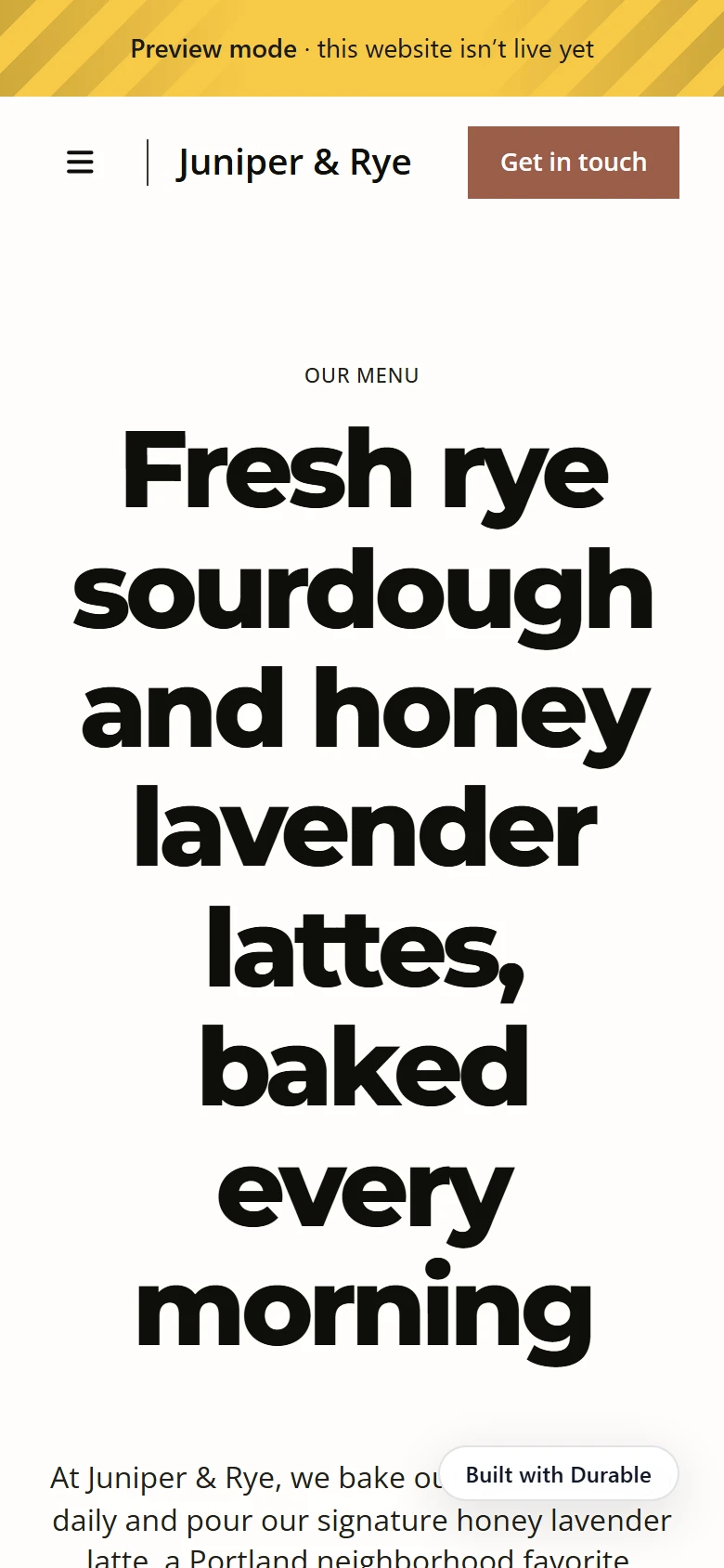 Durable's cafe first draft on a phone with a large headline and a round Built with Durable badge over the text